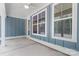 Covered blue patio featuring a ceiling fan, large windows, and a door to the interior at 925 Twin Lakes Rd, Rock Hill, SC 29732