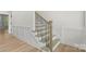 Elegant staircase with wooden treads, black metal railings, and white wainscoting at 925 Twin Lakes Rd, Rock Hill, SC 29732