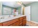 Spacious bathroom with tiled floor, a double sink vanity, and a glass door shower at 9527 Turning Wheel Dr, Charlotte, NC 28214