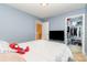 A cozy bedroom with natural light, a comfortable bed, and an organized walk-in closet at 9527 Turning Wheel Dr, Charlotte, NC 28214