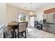 Bright breakfast nook boasts a table, lots of sunlight, and a stainless-steel refrigerator at 9527 Turning Wheel Dr, Charlotte, NC 28214