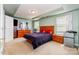 Bright, spacious bedroom with neutral carpet, a tray ceiling, and large windows at 9527 Turning Wheel Dr, Charlotte, NC 28214