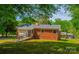 Exterior view of home highlighting the backyard, a ramp, and partial brick facade at 105 Hopper St, Clover, SC 29710
