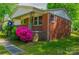 Charming brick house with decorative iron porch railing and well maintained yard and landscaping at 105 Hopper St, Clover, SC 29710