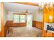 Sunny living area with wood paneling, large windows, and connection to the kitchen at 105 Hopper St, Clover, SC 29710