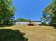Back exterior featuring a light blue house with a wood deck and a green lawn at 109 Bee Tree Ln, Salisbury, NC 28144