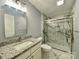 Modern bathroom featuring a granite countertop and a glass-enclosed shower with white marble-style walls at 109 Bee Tree Ln, Salisbury, NC 28144