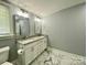 Bathroom featuring double vanity with granite countertop, great lighting, and marble-like tiling on the floor at 109 Bee Tree Ln, Salisbury, NC 28144