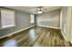 Bright bedroom with wood floors, ceiling fan, and large windows, perfect for relaxing and unwinding at 109 Bee Tree Ln, Salisbury, NC 28144