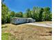 Charming light blue house with a concrete driveway and a well-maintained lawn at 109 Bee Tree Ln, Salisbury, NC 28144