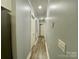 Hallway with freshly painted walls and laminate floors at 109 Bee Tree Ln, Salisbury, NC 28144