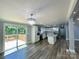 Open-concept kitchen with gray wood floors, white cabinets, and an island, perfect for modern living and entertaining at 109 Bee Tree Ln, Salisbury, NC 28144