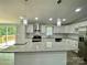 Bright kitchen featuring white cabinets, stainless appliances, granite countertops, and a stylish island for dining at 109 Bee Tree Ln, Salisbury, NC 28144