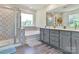 Luxurious bathroom with dual sinks, soaking tub, separate shower, and modern tile accents at 11010 Redcoat Hill Ln # 33, Huntersville, NC 28078