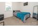 Comfortable bedroom features neutral carpet, closet, and lots of natural light at 11010 Redcoat Hill Ln # 33, Huntersville, NC 28078