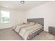 Cozy bedroom with a queen-size bed, soft carpet, and a window offering a view of the outdoors at 11010 Redcoat Hill Ln # 33, Huntersville, NC 28078