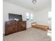 Bright bedroom featuring a large dresser and two windows that provide plenty of natural light at 11010 Redcoat Hill Ln # 33, Huntersville, NC 28078