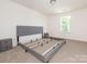 Bright bedroom with natural light and a large bed frame ready for personalization and comfort at 11010 Redcoat Hill Ln # 33, Huntersville, NC 28078