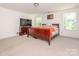 Spacious primary bedroom with carpet flooring, lots of natural light, and ceiling fan at 11010 Redcoat Hill Ln # 33, Huntersville, NC 28078