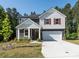 Well-maintained home with a manicured lawn and inviting entrance, featuring a spacious driveway and two-car garage at 11010 Redcoat Hill Ln # 33, Huntersville, NC 28078