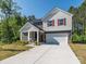 Inviting home showcasing a manicured lawn, clean driveway, and charming architectural details that offers curb appeal and convenience at 11010 Redcoat Hill Ln # 33, Huntersville, NC 28078