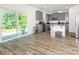 Stylish kitchen with gray cabinets, stainless appliances, and access to outdoor living at 11010 Redcoat Hill Ln # 33, Huntersville, NC 28078
