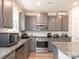Kitchen showcasing gray cabinets, granite countertops, and stainless steel appliances at 11010 Redcoat Hill Ln # 33, Huntersville, NC 28078