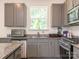Open kitchen design features grey cabinets, granite countertops, and stainless steel appliances at 11010 Redcoat Hill Ln # 33, Huntersville, NC 28078