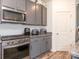This kitchen showcases grey cabinets, stainless appliances, and durable granite counters at 11010 Redcoat Hill Ln # 33, Huntersville, NC 28078