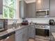 Modern kitchen features stainless steel appliances, granite countertops, and grey cabinets at 11010 Redcoat Hill Ln # 33, Huntersville, NC 28078