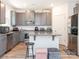 Well-equipped kitchen featuring gray cabinetry, granite countertops, and stainless steel appliances at 11010 Redcoat Hill Ln # 33, Huntersville, NC 28078