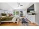 Bright bedroom showcases hardwood floors, a ceiling fan, and a large window framing scenic outdoor views at 1115 Greenleaf Ave # B, Charlotte, NC 28202