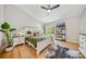 Spacious bedroom with hardwood floors, a ceiling fan, and stylish furniture offering a comfortable living space at 1115 Greenleaf Ave # B, Charlotte, NC 28202