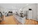 Open-concept kitchen with a large island, stainless steel appliances, and bar stool seating at 1115 Greenleaf Ave # B, Charlotte, NC 28202