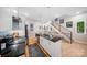 Chic kitchen with a center island featuring bar stool seating, white cabinets, and modern lighting at 1115 Greenleaf Ave # B, Charlotte, NC 28202