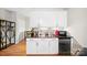 Compact kitchenette area with white cabinetry, sleek black countertops, and stainless steel refrigerator at 1115 Greenleaf Ave # B, Charlotte, NC 28202