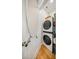 Bright laundry room features a stackable washer and dryer and an ironing board ready for use at 1115 Greenleaf Ave # B, Charlotte, NC 28202