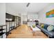Bright living room featuring hardwood floors, modern furniture, and a compact kitchenette at 1115 Greenleaf Ave # B, Charlotte, NC 28202
