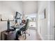 Modern home office with a large window, sleek desk setup, and ample natural light creating a productive workspace at 1115 Greenleaf Ave # B, Charlotte, NC 28202