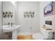 Elegant powder room with pedestal sink, modern fixtures, and stylish decor at 1115 Greenleaf Ave # B, Charlotte, NC 28202