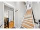 Modern staircase with wood treads, black metal railing, and neutral wall colors at 1115 Greenleaf Ave # B, Charlotte, NC 28202