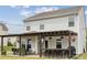 Backyard view of patio area featuring a bar with seating, grill, and outdoor tv at 1218 Juddson Dr, Waxhaw, NC 28173