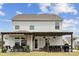 View of the backyard with a covered patio, bar with seating and grill at 1218 Juddson Dr, Waxhaw, NC 28173