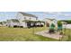 Spacious backyard with pergola, outdoor dining, grill, and a charming brick fire pit area at 1218 Juddson Dr, Waxhaw, NC 28173