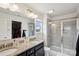 Well-lit bathroom with dual sinks, granite countertops, large mirror, and a glass-enclosed shower at 1218 Juddson Dr, Waxhaw, NC 28173