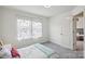 Cozy bedroom features natural light through floral curtains and neutral-toned walls and carpet at 1218 Juddson Dr, Waxhaw, NC 28173
