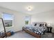 Inviting bedroom with black metal bed, matching graphic quilt set, and windows with views at 1218 Juddson Dr, Waxhaw, NC 28173