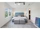 A serene bedroom featuring a plush turquoise headboard, patterned bedding and plenty of natural light at 1218 Juddson Dr, Waxhaw, NC 28173