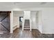 Spacious entry foyer with stairs, a bench with coat hooks, dark wood floors and barn door at 1218 Juddson Dr, Waxhaw, NC 28173