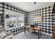 Home office with checkered wallpaper, a light wood desk and large window overlooking the backyard at 1218 Juddson Dr, Waxhaw, NC 28173